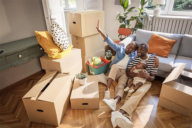 A family sitting among moving boxes together.